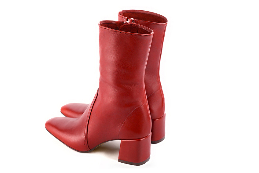 Scarlet red women's ankle boots with a zip on the inside. Square toe. Medium block heels. Rear view - Florence KOOIJMAN